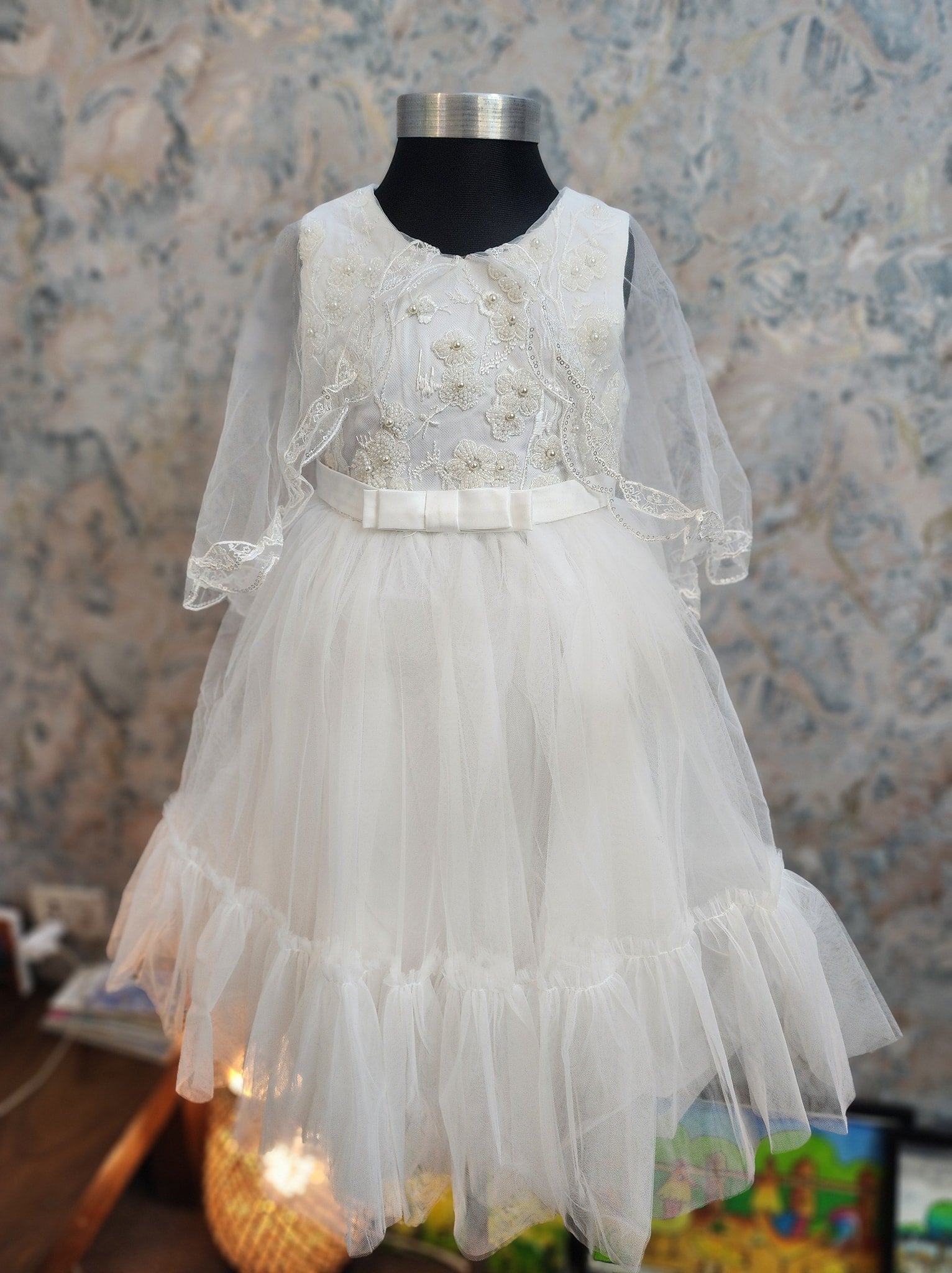 White princess dress with delicate details and flowing fabric for little girls, perfect for birthdays and special celebrations