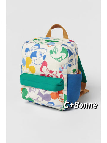 Matching Mickey Mouse print backpack in white canvas with vibrant patchwork character design featuring green pocket and brown handles - colorful multi-functional kids school bag with rain cover