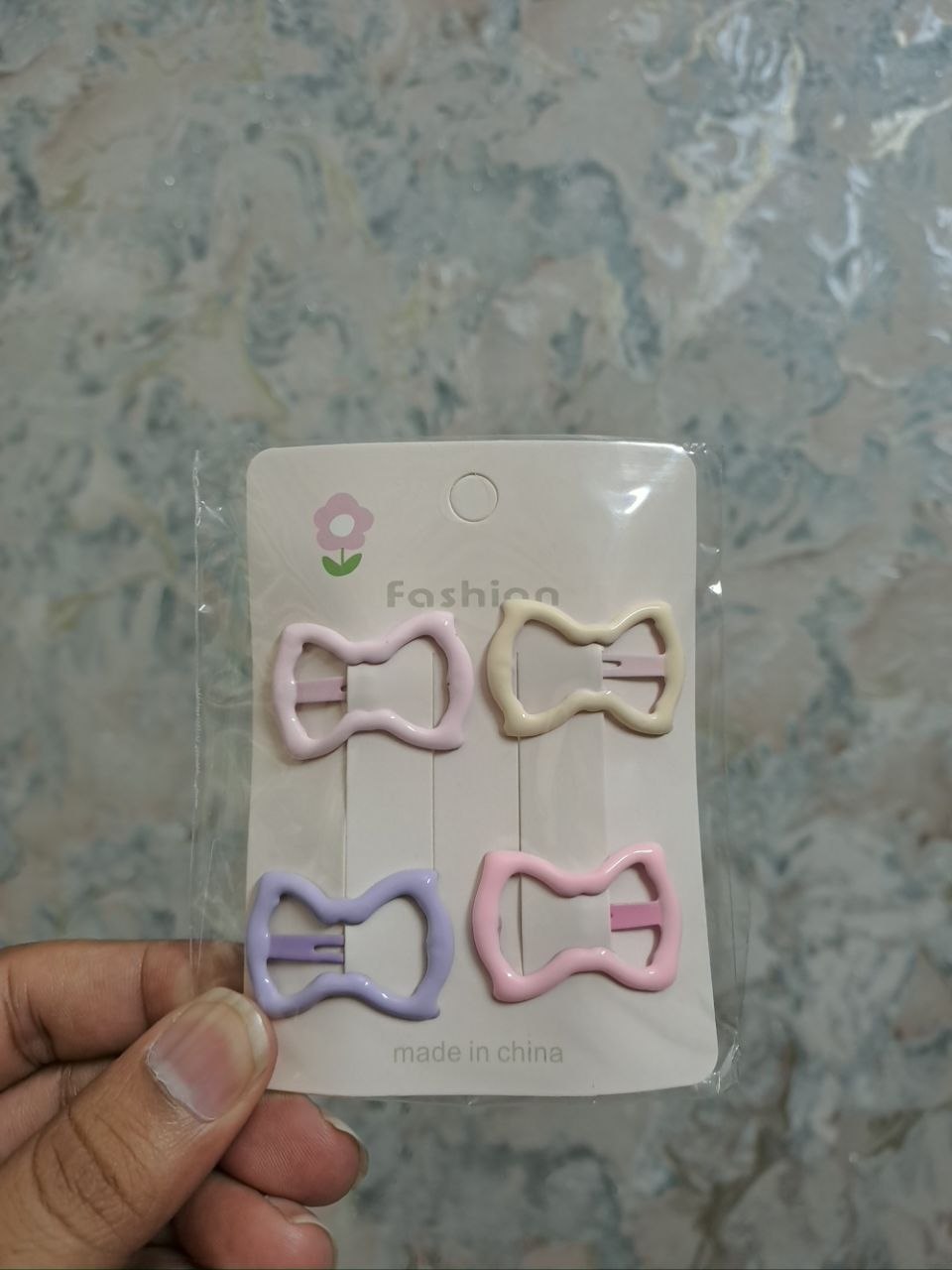 Assorted hair clip collection including pastel bows, rainbow star cutouts, and colorful butterfly clips for girls