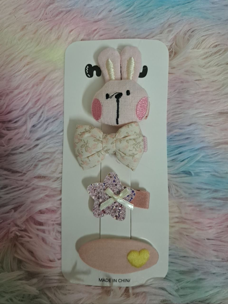 Miyu brand coordinated fabric hair clips including gingham bows, bunny face, ribbons, and embellished pieces in pink and cream tones for girls