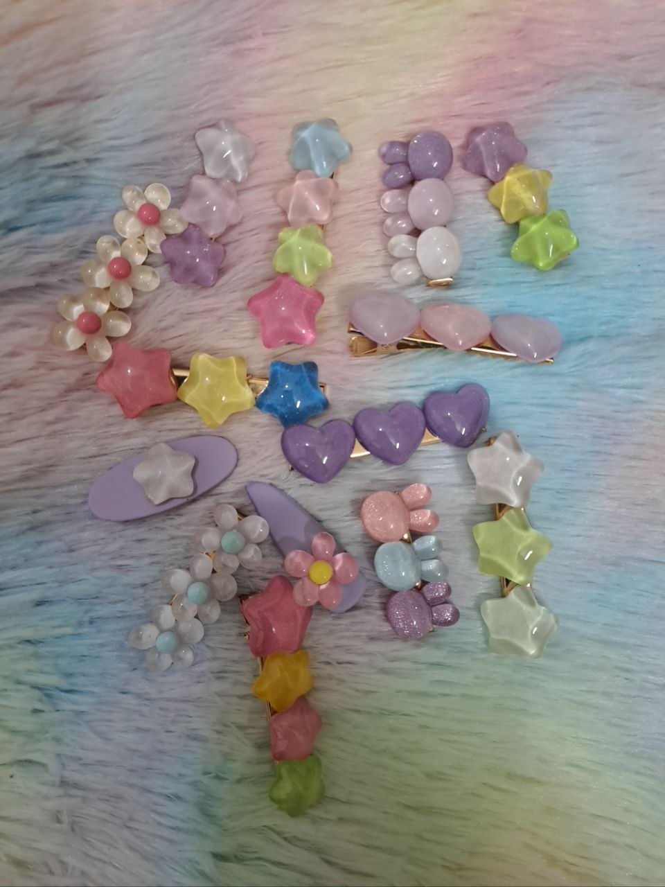 Assorted glossy resin hair clips in star, heart, flower, and bead shapes with smooth colorful finish for girls
