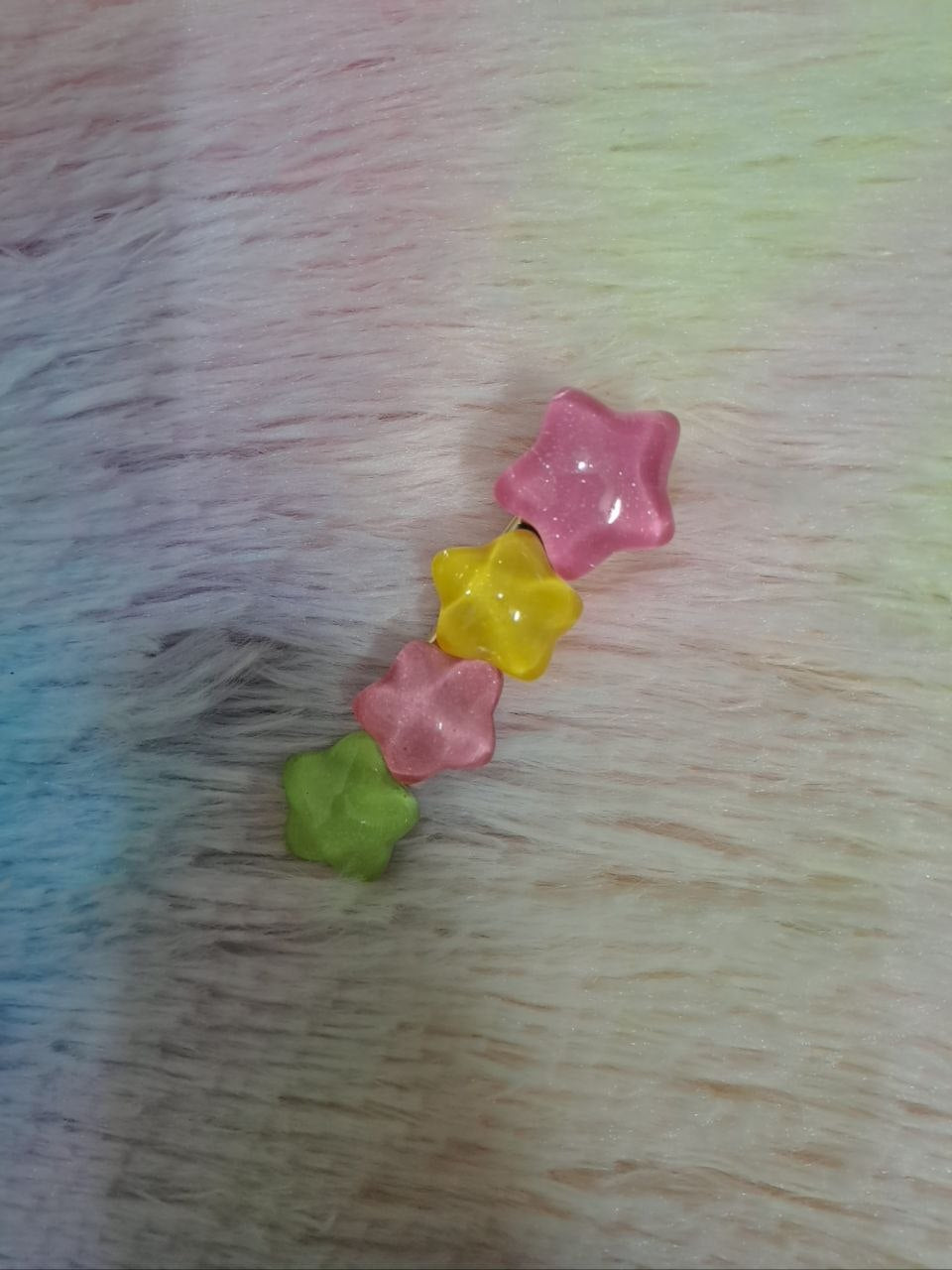Assorted glossy resin hair clips in star, heart, flower, and bead shapes with smooth colorful finish for girls