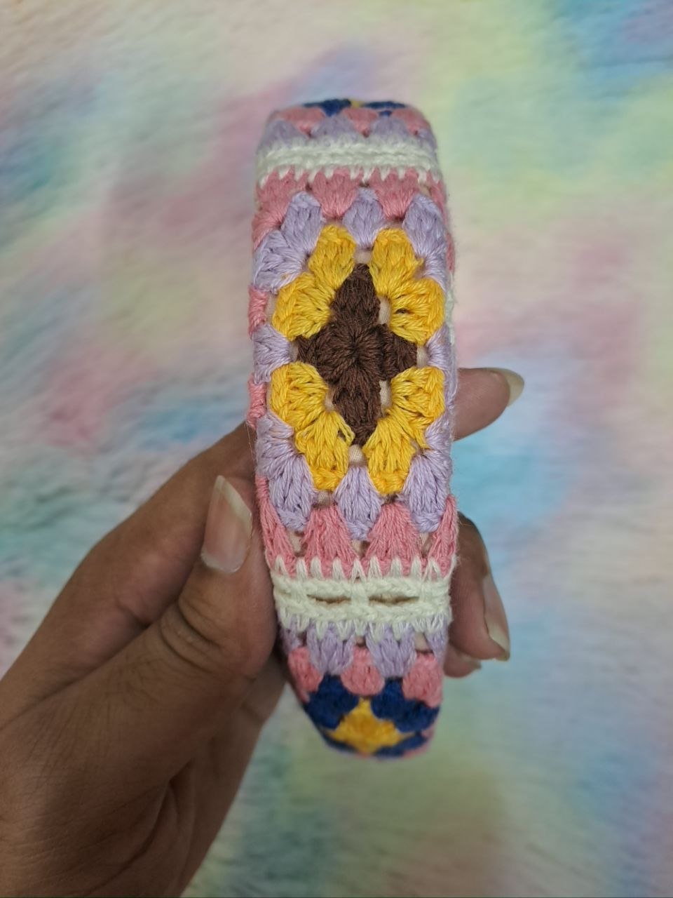 Handcrafted crocheted headbands with intricate braided floral patterns in multicolor combinations including pink, green, blue, cream, and purple for girls