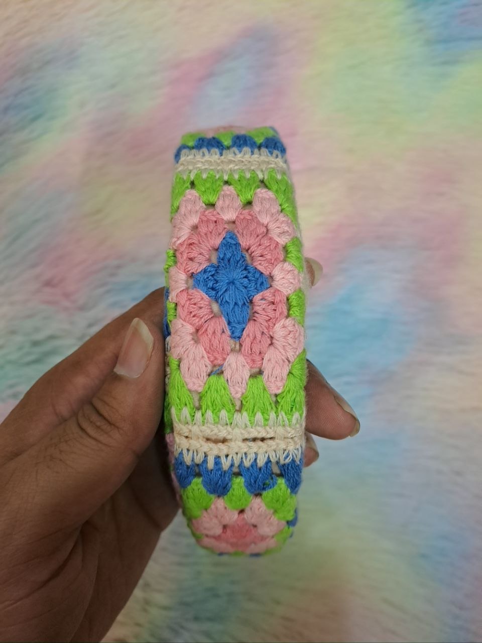 Handcrafted crocheted headbands with intricate braided floral patterns in multicolor combinations including pink, green, blue, cream, and purple for girls