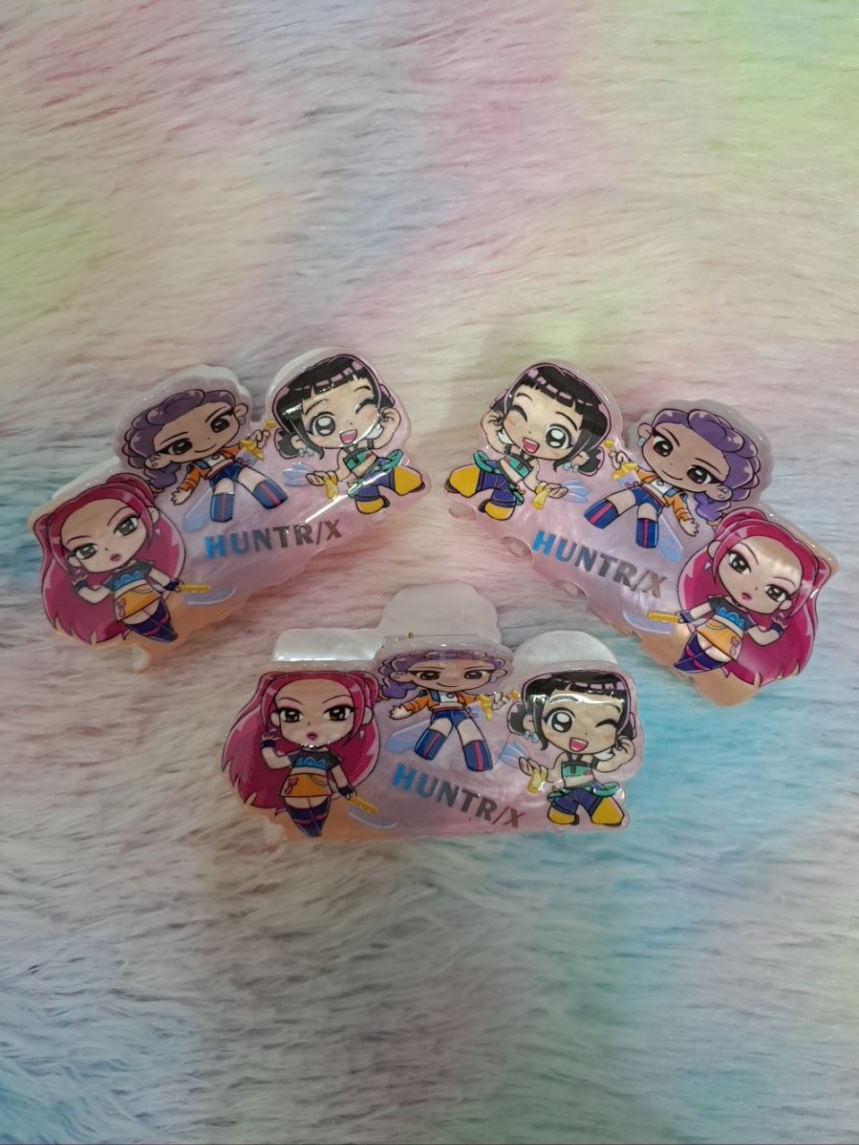 HUNTRIX brand clear acrylic snap hair clips featuring colorful chibi-style anime character graphics for girls