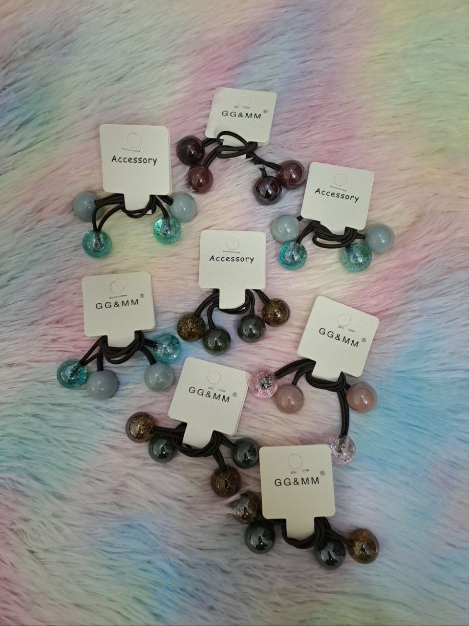 GG&MM brand elastic hair ties with multiple decorative balls in coordinating colors including glitter-filled, solid, and metallic finishes for girls