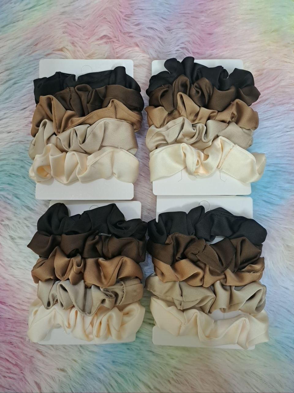 Satin scrunchies in coordinated neutral tones including black, brown, tan, and cream for versatile elegant styling for girls