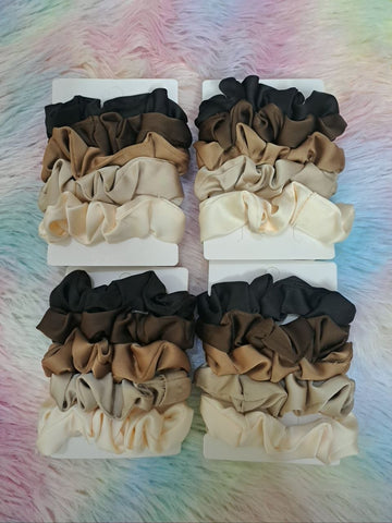 Satin scrunchies in coordinated neutral tones including black, brown, tan, and cream for versatile elegant styling for girls