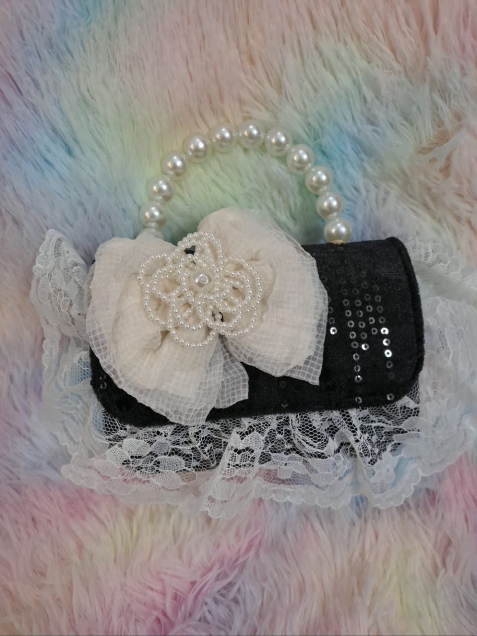 Black sequined evening bag with delicate ivory lace trim, pearl bead handle, and ivory tulle flower for girls