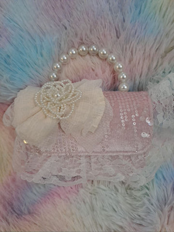 Soft pink sequined evening bag with delicate lace trim, pearl bead handle, and ivory tulle flower for girls