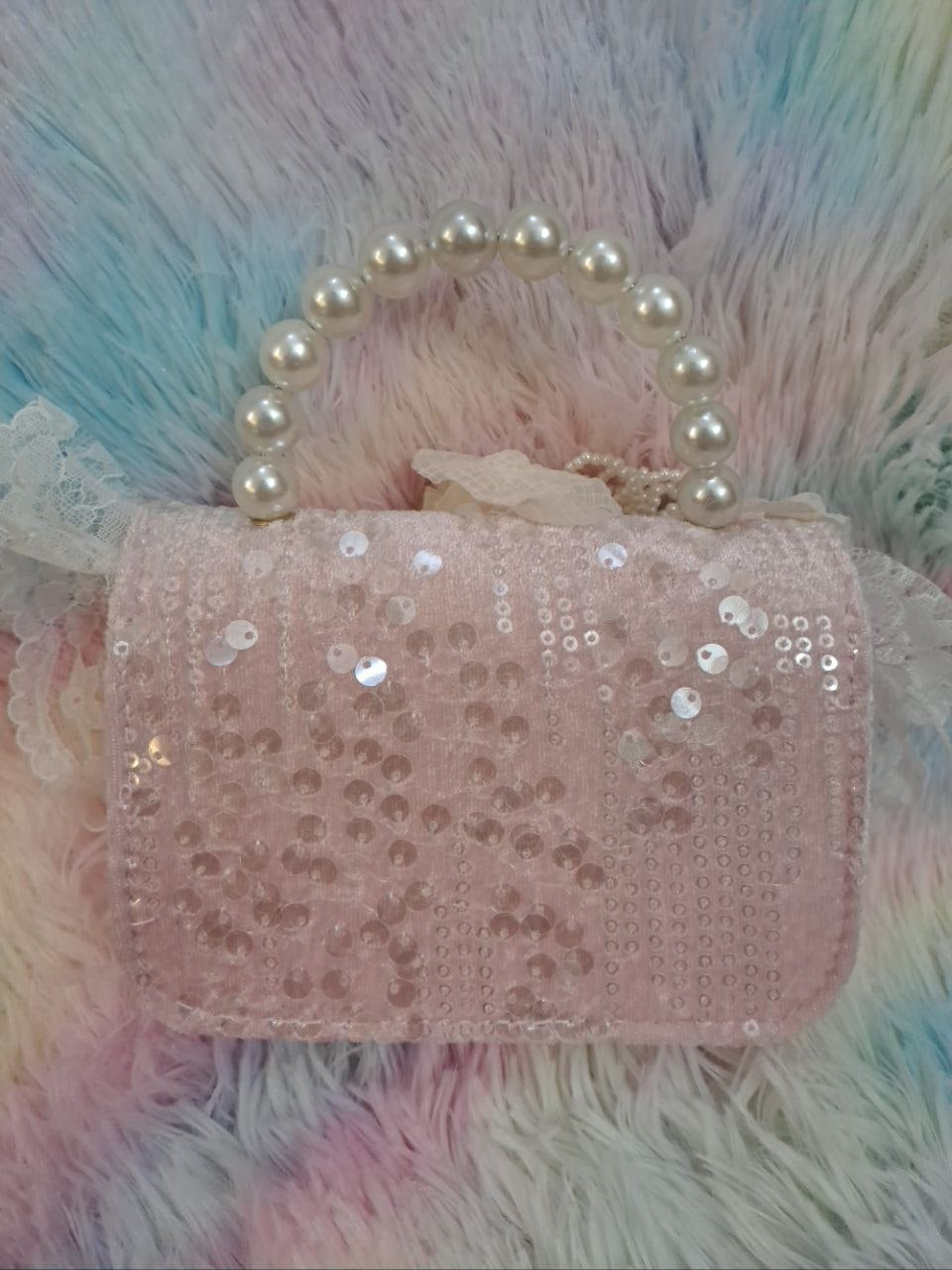 Soft pink sequined evening bag with delicate lace trim, pearl bead handle, and ivory tulle flower for girls