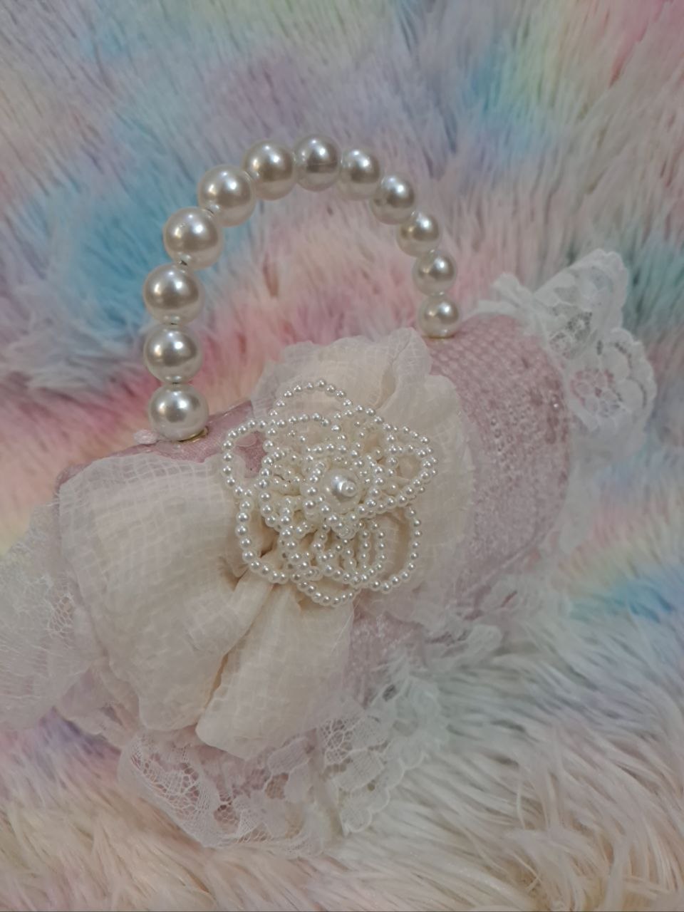 Soft pink sequined evening bag with delicate lace trim, pearl bead handle, and ivory tulle flower for girls