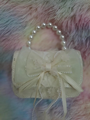 Cream evening bag with lace overlay, pearl bead handle, tulle bow with embroidered floral details and pearl accents for girls
