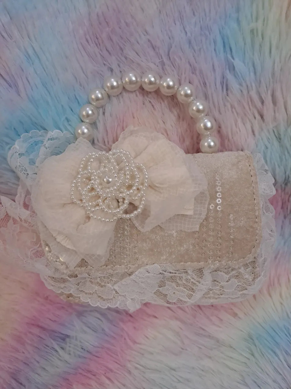 Beige lace-covered evening bag with delicate sequins, pearl bead handle, and ivory tulle flower with pearl embellishments for girls