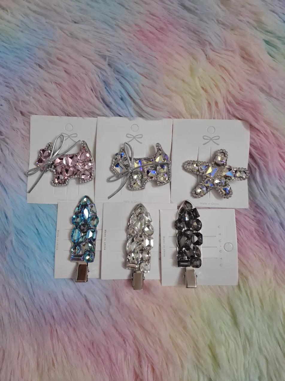 Crystal rhinestone hair clips set of 6 styles featuring pink bear with bow, AB iridescent bear with bow, star barrette, blue teardrop pin, clear teardrop pin, and smoky dark teardrop pin displayed on presentation cards