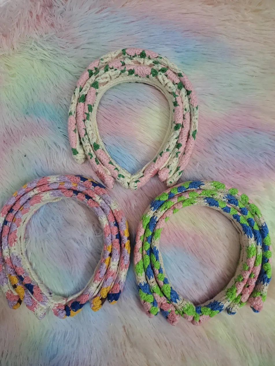 Crochet knit headbands in three multicolour colourways: pink and green botanical, lavender yellow and navy eclectic, and pink blue and green bright, with bobble stitch texture, firm inner band structure, handmade aesthetic hair accessory
