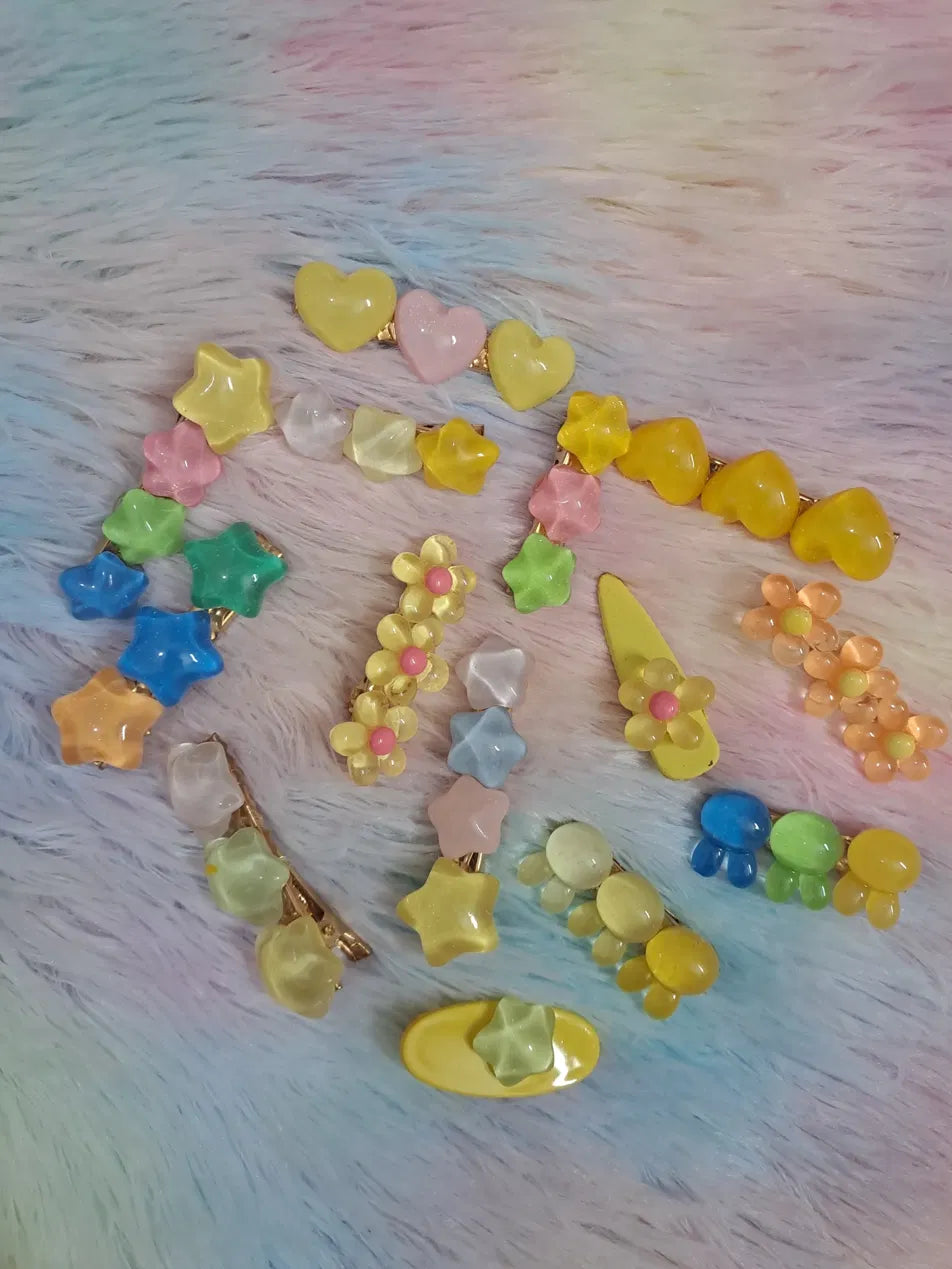 Candy jelly colourful mini hair clips set featuring puffy hearts, sparkly stars, daisy flowers, cloud shapes and drop clusters in assorted pastel and bright colours with gold-toned metal clip bases, kawaii styling hair pins